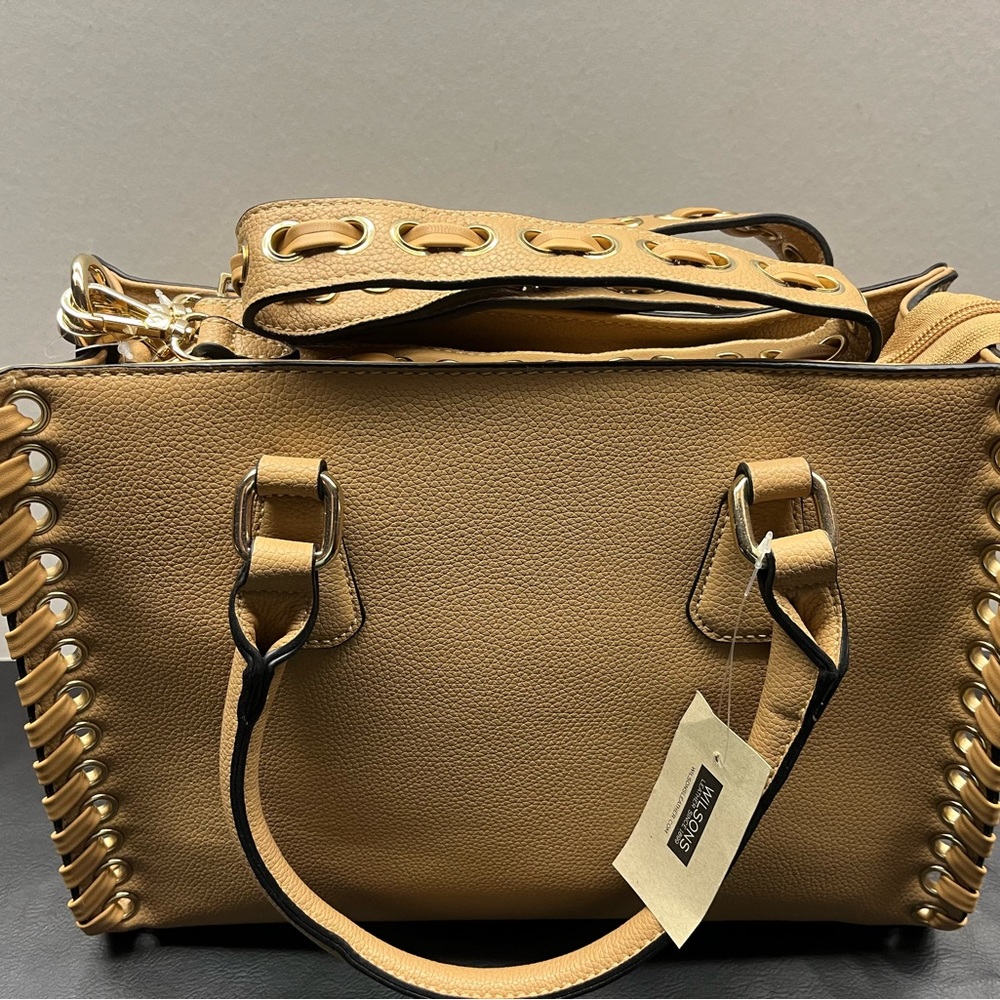 Stylish tan purse - two in one - hand strap and shoulder straps for both purses.